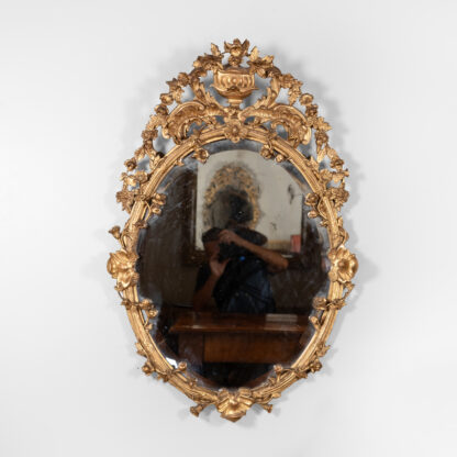 Carved French Giltwood Oval Mirror with Urn Crest and Floral Garlands, Circa 1870