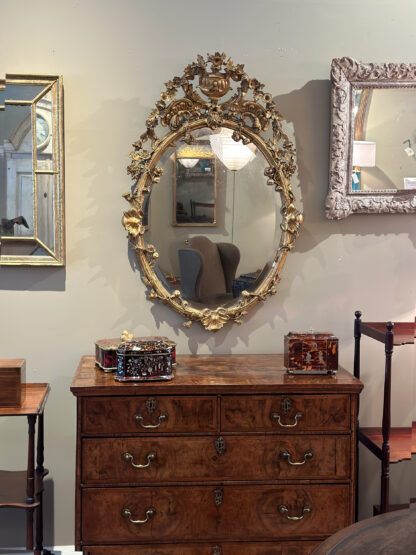 Carved French Giltwood Oval Mirror with Urn Crest and Floral Garlands, Circa 1870