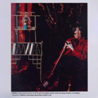 Madeleine Castaing posing next to one of the gilt-brass bamboo stands, which were always stocked in her boutique.